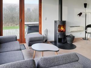 a living room with a couch and a fireplace at 7 person holiday home in Vestervig in Vestervig