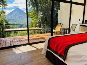 a bedroom with a view of the ocean and mountains at Sangregado Lodge in Fortuna