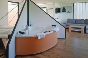 a bathroom with a bath tub in a living room at 4 star holiday home in Gaal im Murtal in Pirkach