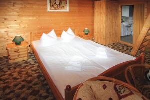 a bedroom with a large bed with white pillows at Blockhouses at Fährsee, Templin in Templin