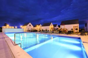a swimming pool at night with blue lights at Apartment in Rogowo near Baltic Sea Beach in Rogowo