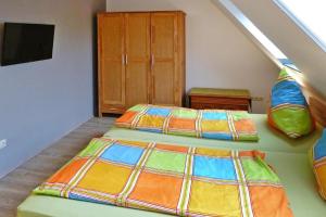 two beds in a room with an attic at Holiday Apartment An der Meiße, Bergen in Bleckmar