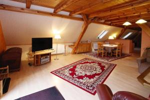 a large living room with a television and a table at Apartment, Parmen near Feldberg in Parmen