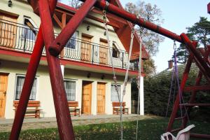 a playground in front of a house with two benches at holiday home, Pobierowo in Pobierowo