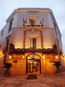 a large white building with a door and a balcony at Hotel San Nicola in Altamura