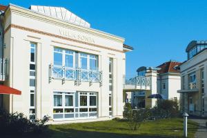 a white building with a sign on the front of it at Apartment Villa Sonja, Zingst in Zingst
