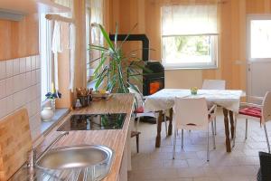 a kitchen with a sink and a table with a dining room at House, Parmen near Feldberg in Parmen
