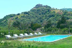 una piscina con tumbonas y una montaña en Holiday home, Castiglione di Sicilia, en Castiglione di Sicilia