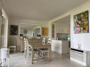 a kitchen and dining room with a table and chairs at Villa Provincial, Cypress Lakes Resort, Two Bedrooms both with Private Ensuites, 2 KING or 4 SINGLE BEDS, Sensational Views in Pokolbin