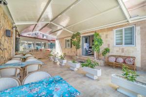 a patio with tables and chairs and potted plants at Apartments Near to City Center and Beach in Marmaris