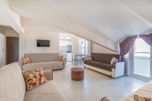 a living room with two couches and a table at Apartments Near to City Center and Beach in Marmaris