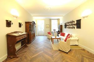 a living room with a couch and chairs and a table at Mansion in Garz with garden in Garz-Rügen