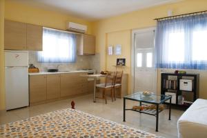 a small kitchen with a table in a room at Mirella Studios in Loutra Oraias Elenis 