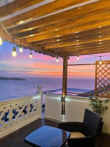 a balcony with a view of the ocean at sunset at Penthouse 360 Cartagena in Cartagena de Indias