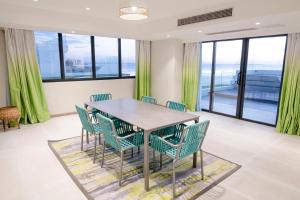 a dining room with green chairs and a table at Lime Resort Manila in Manila
