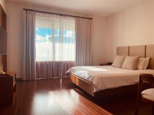 a bedroom with a bed and a large window at ArdenHill Resort & Golf in Jeju +94 photos
