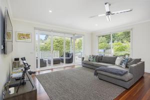 a living room with a couch and a tv at Lady Nelson in Sorrento