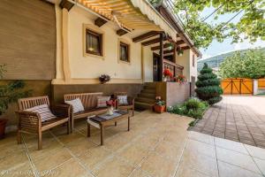 a patio with two benches and a table on a house at La Nana in Sibiel