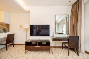 a hotel room with a desk and a mirror at Emaar Fashion Avenue - Formerly Address Dubai Mall Four Apple in Dubai