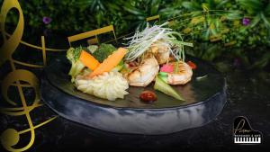 a plate of food with shrimp vegetables and rice at Mariana Hotel Erbil in Erbil