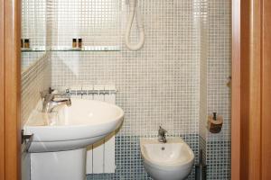 a white bathroom with a sink and a shower at Apartment in Vada near restaurants in La Cinquantina