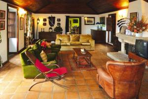 a living room filled with furniture and a fireplace at holiday home, Folhada in Marco de Canaveses