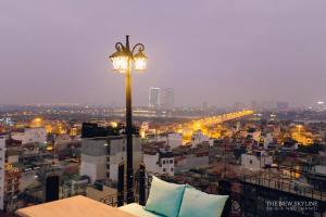 a street light on top of a city at night at Hanoi Tirant Hotel in Hanoi