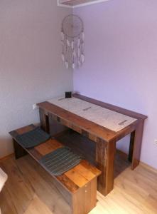 a wooden table with a shelf in a room at Pension Hüttendorf 49 gradnord in Bayerisch Eisenstein +22 photos