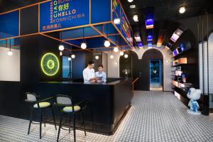 two people standing at a bar in a restaurant at lyf Mid-Town Hangzhou in Hangzhou