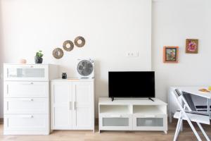 A television and/or entertainment centre at Home2Book Sea View Studio Puerto de la Cruz