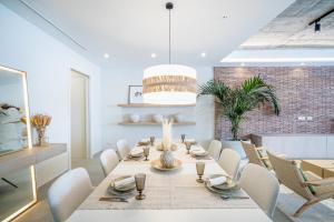 a dining room with a long table and chairs at Casona Seis Lunas Apartment in Marbella