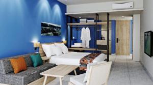 a bedroom with a large bed and a couch at Tahuna Beach Hotel and Resort in Taruna
