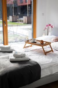 two beds with towels and a table on them at Maya's Flats & Resorts 18 - Nadmotlawie in Gdańsk