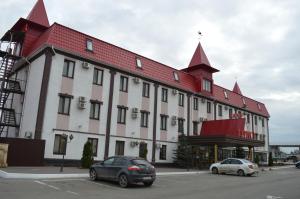 a large white building with a red roof at Turist Hotel in Saratov