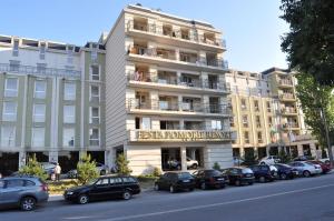 a large building with cars parked in front of it at Festa Studio in Pomorie