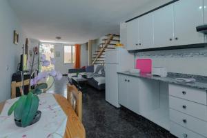 a kitchen and a living room with a table and a dining room at Tenerra II in El Paso