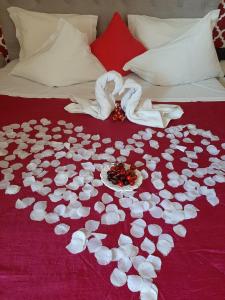 a white blanket with flowers on top of it at Hotel Kamanga in Tomar