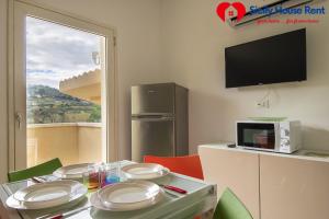 a kitchen with a table with plates on it at Borgo Aranci - Appartamento in Villa Garofalo - 15B in Castellammare del Golfo