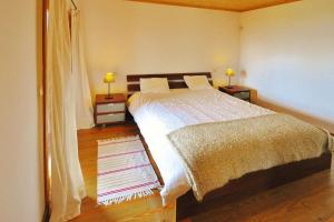 a bedroom with a bed and two night stands with lamps at Holiday homes Quinta dos Curubás, Vila Franca do Campo in Vila Franca do Campo