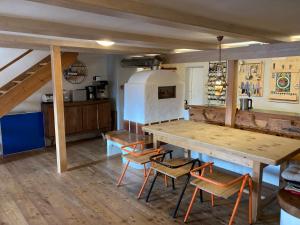 a kitchen with a wooden table and chairs at Sport- und Seminarhaus Walsertal 