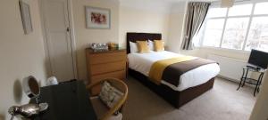 Ένα ή περισσότερα κρεβάτια σε δωμάτιο στο Hampton Lodge En-Suite Rooms with Free Parking