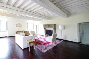 sala de estar con muebles blancos y TV en Residence Villa Il Palagio, Rignano sull" Arno, en Rignano sullʼArno