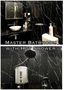 a black bathroom with a sink and a mirror at Harris Homestay Gerik Town, Free Wifi & Netflix in Gerik