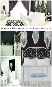 a room with a bed and a bedroom with art condition at Harris Homestay Gerik Town, Free Wifi & Netflix in Gerik