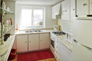 a kitchen with white cabinets and a sink and a window at Mill Barcelos - PON03276-U in Barcelos