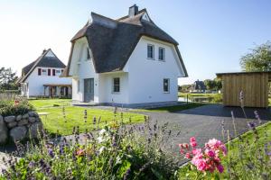 a white house with a black roof at Holiday house, Fuhlendorf in Fuhlendorf