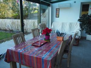 a table with a colorful table cloth on a patio at gure xokoa in Urrugne +38 photos