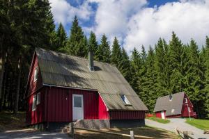 a red barn with a gambrel roof at Holiday complex Erzgebirge Idyll, Breitenbrunn in Breitenbrunn