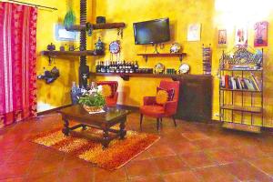 sala de estar con chimenea, mesa y sillas en Holiday home Castiglione di Sicilia, en Castiglione di Sicilia
