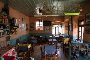 a restaurant with tables and chairs in a room at Napoleon Zaglis Guesthouse in Kalarrites